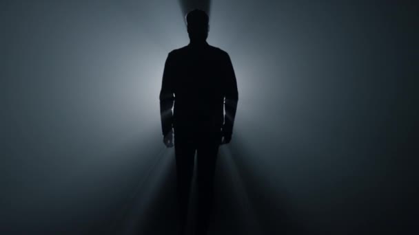 depositphotos_478416548-stock-video-silhouette-man-walking-in-darkness